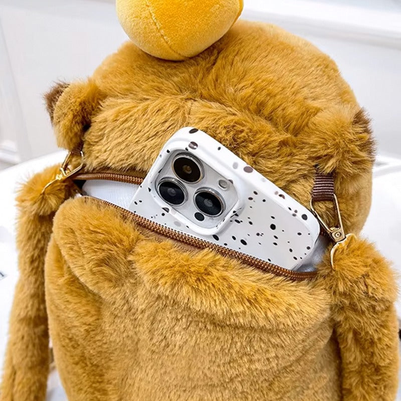 Capybara backpack open zipper pocket with smartphone inside, showing its soft plush material and size.