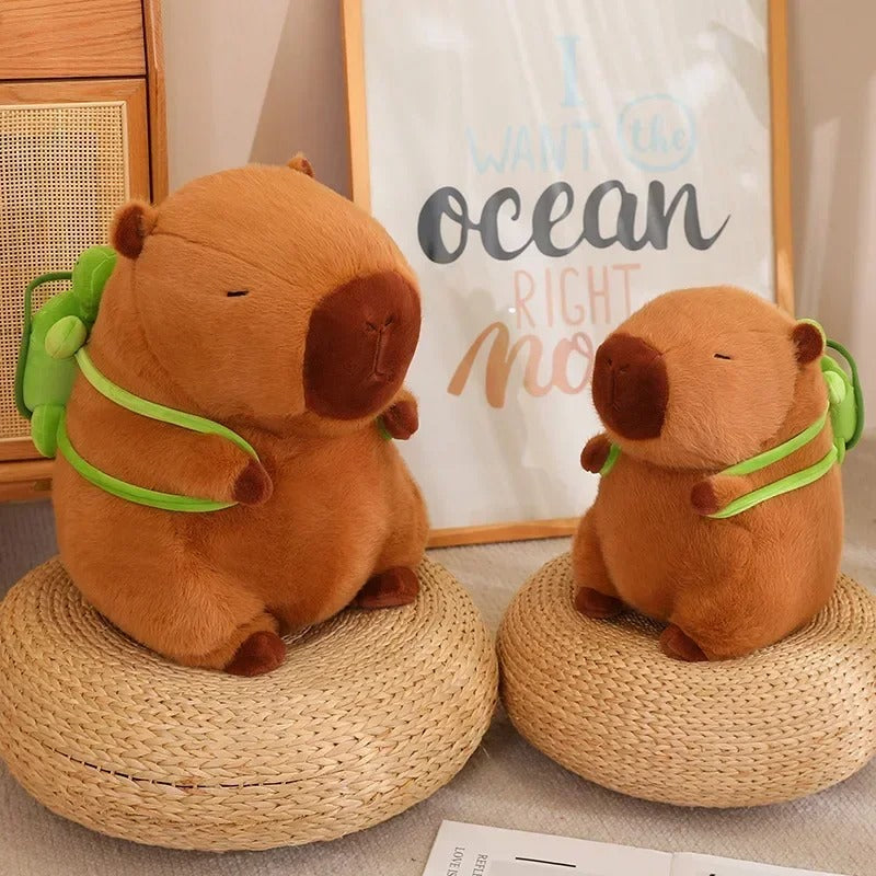 Two capybara plush toys with green turtle backpacks sitting side-by-side – cute backpack plush animals styled for cozy home decor.