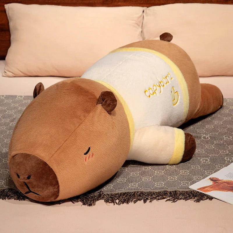 Giant capybara plush pajama party edition in yellow duck pajamas, soft stuffed animal body pillow.