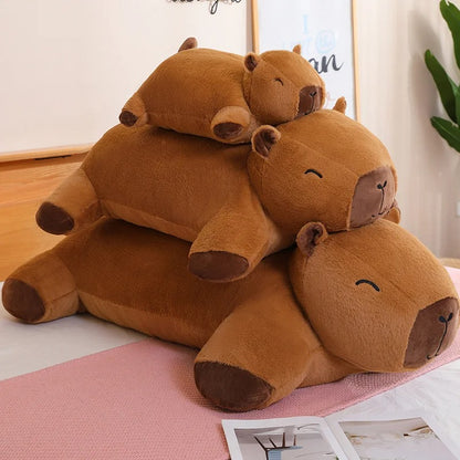 Stack of three giant capybara plush toys in different sizes, Jolly Dreams stuffed animal set.