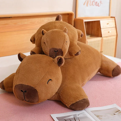 Giant capybara plush toy with smaller baby capybara stuffed animal on top, Jolly Dreams edition.