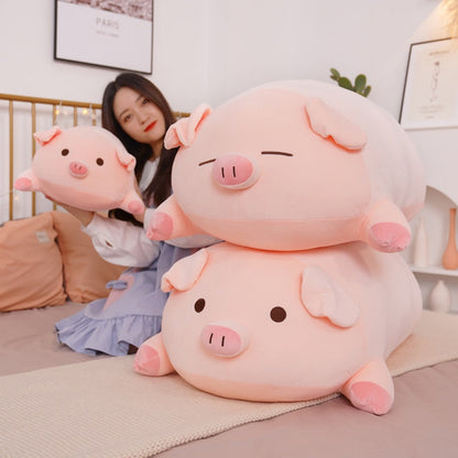 A person holding a small pink piggy plush next to two large, stacked kawaii squishy piggy plushies with different facial expressions.