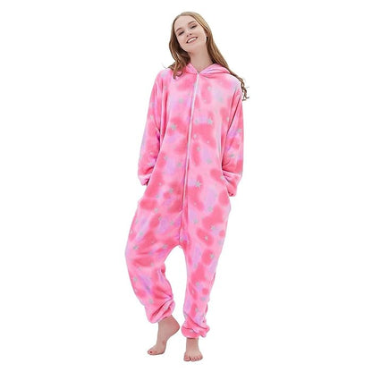 Relaxed pose in pink fleece unicorn onesie for adults featuring pastel star pattern.