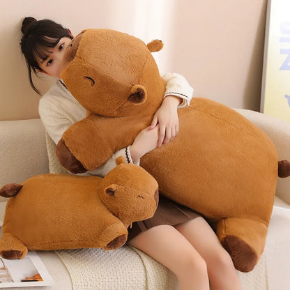 Girl hugging a soft giant capybara plush toy, oversized stuffed animal pillow for comfort.
